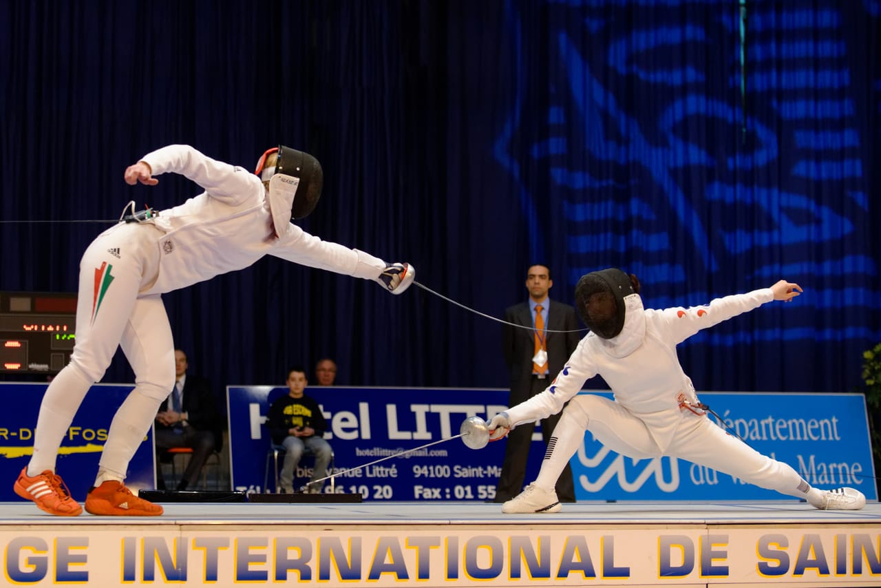 Epee fencers in dynamic lunge at international competition