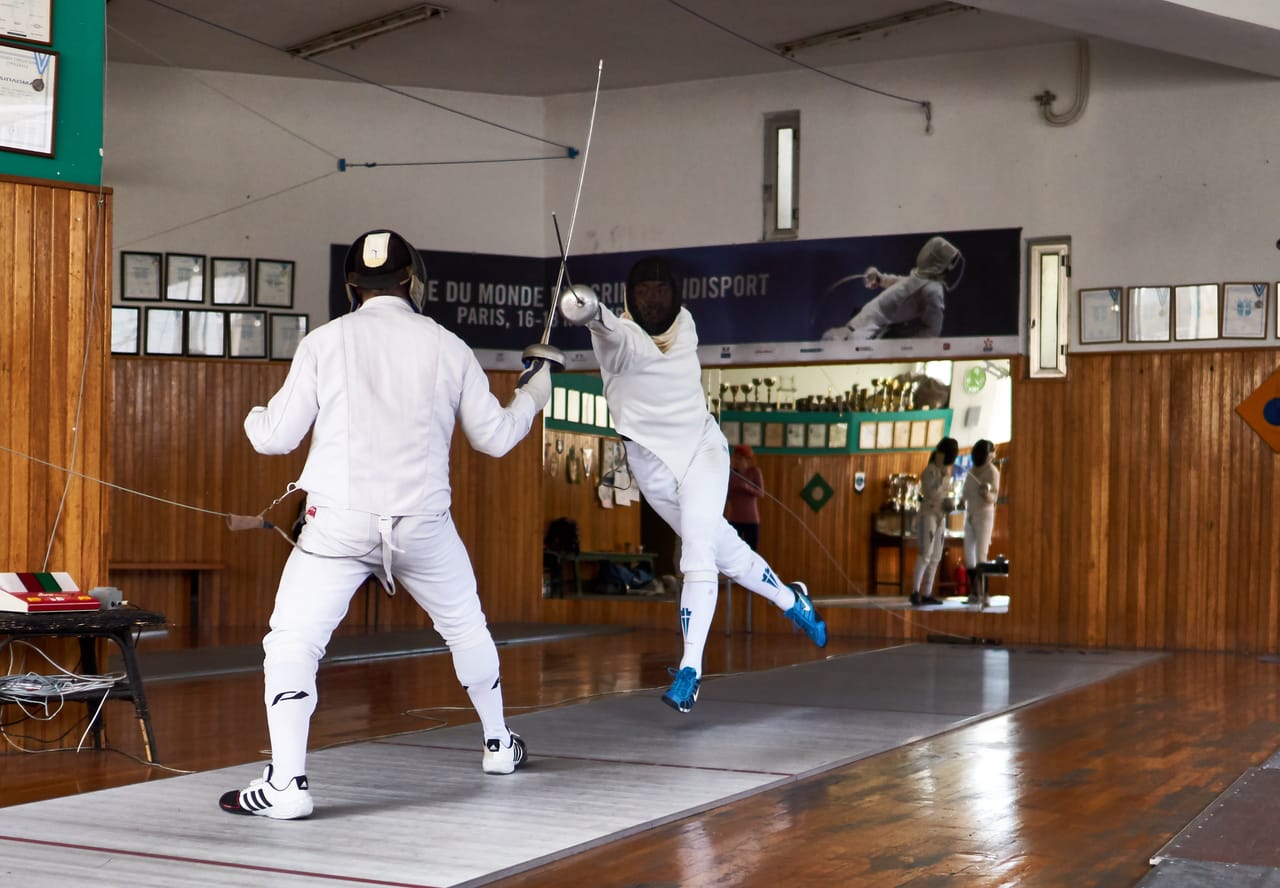 Epee fencer executing an explosive fleche attack